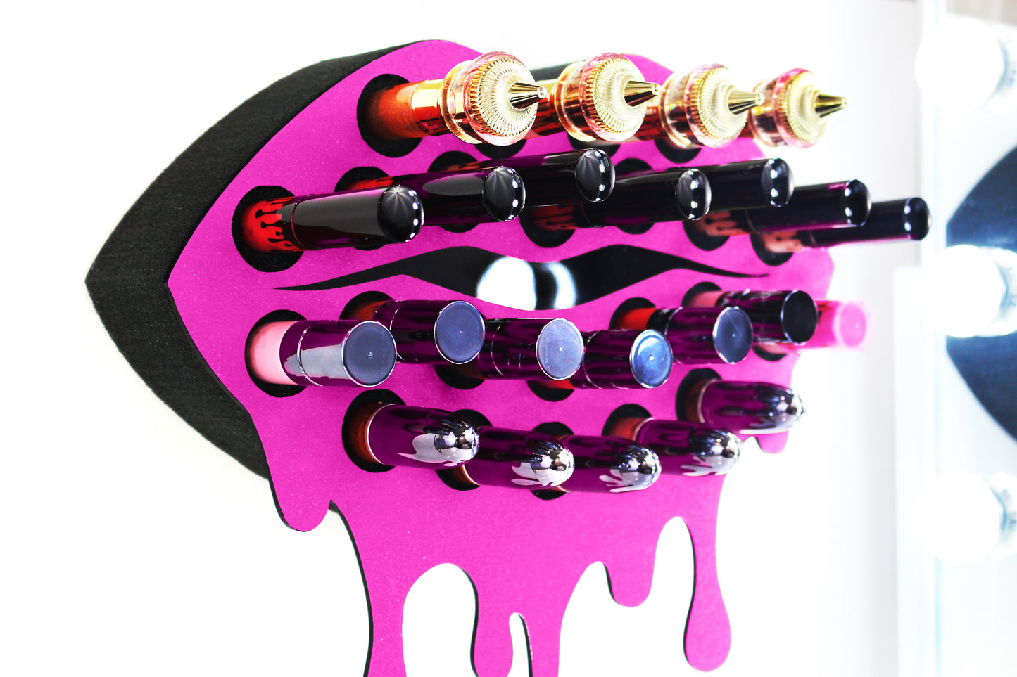 Dark Pink Medium Lip Design Lipstick Organizer holding 23 lipsticks mounted on the wall with lipstick easily accessible and organized. Wall Mounted Lipstick Organizer that looks like wall art. Shown zoomed in to display detail.