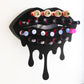 Black Medium Lip Design Lipstick Organizer holding 23 lipsticks mounted on the wall, keeping lipstick organized and easy to reach. This wall mounted makeup organizer looks like art on the wall of your bathroom or makeup room.