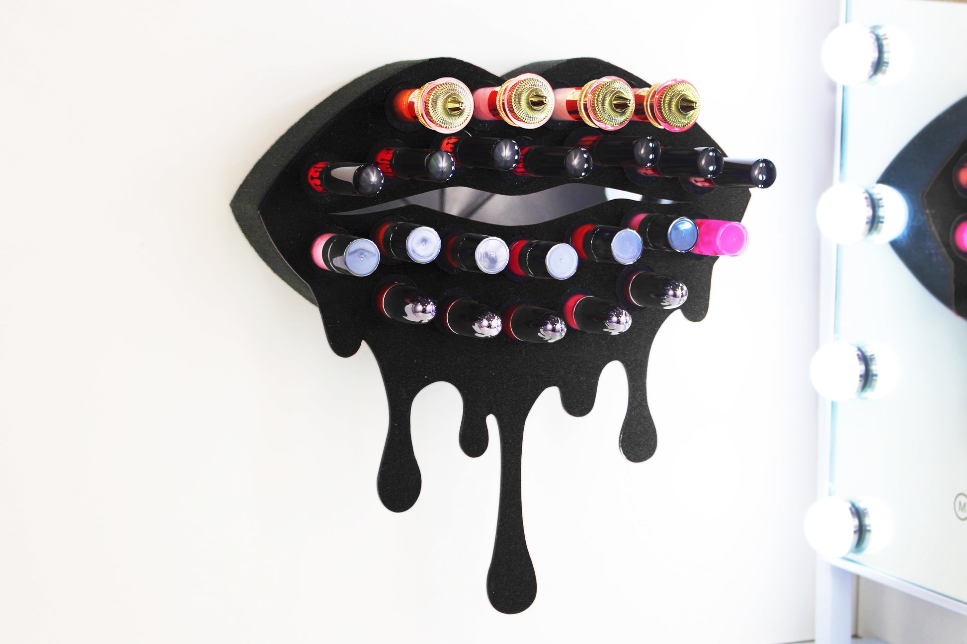 Black Medium Lip Design Lipstick Organizer holding 23 lipsticks mounted on the wall, keeping lipstick organized and easy to reach. This wall mounted makeup organizer looks like art on the wall of your bathroom or makeup room.