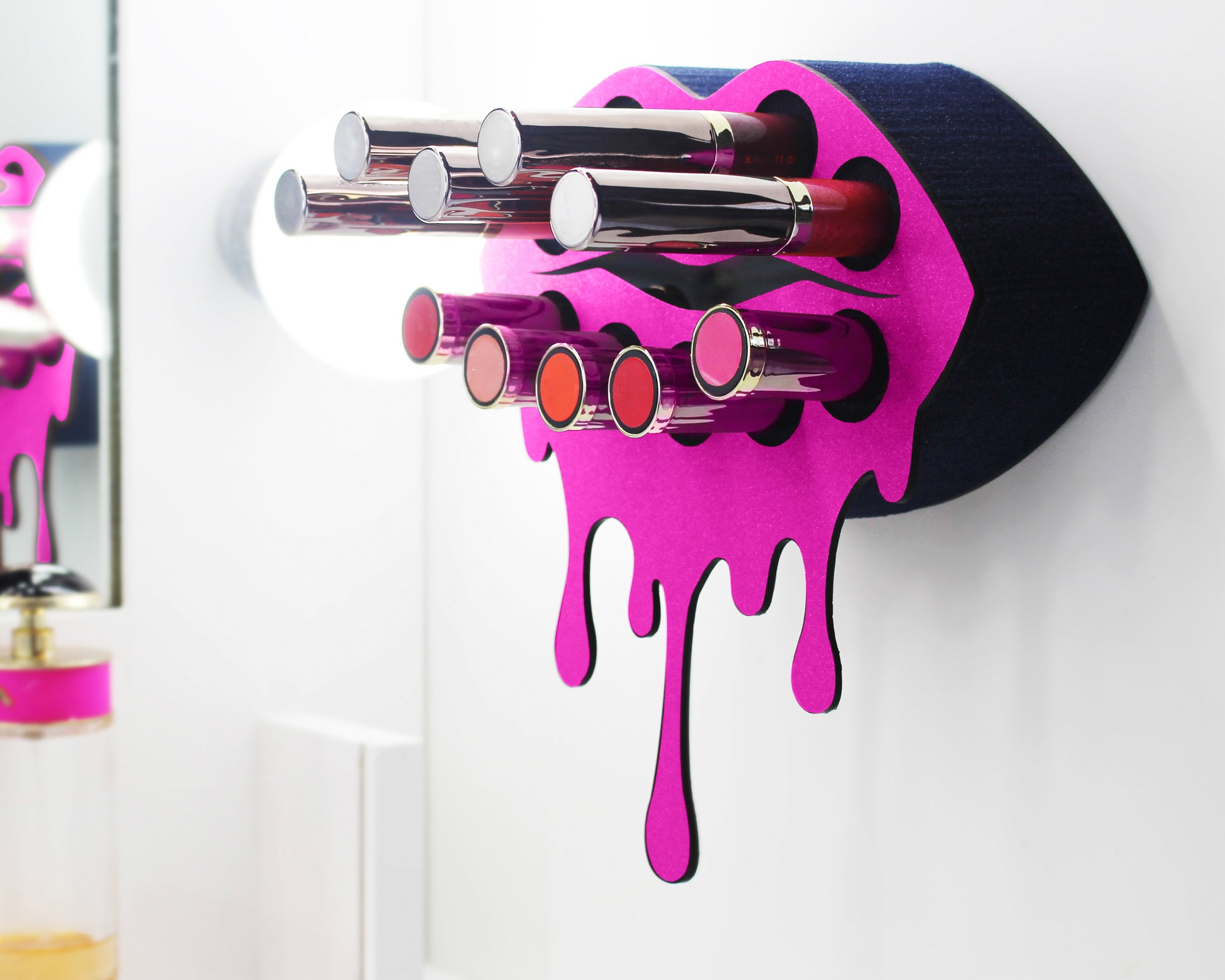 Dark Pink Small Lip Design Lipstick Organizer holding 10 lipsticks mounted on the wall with lipstick easily accessible and organized. Hanging Lipstick Holder that looks like wall art.