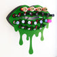 Green Medium Lip Design Lipstick Organizer holding 23 lipsticks mounted on the wall, keeping lipstick organized and easy to reach. This wall mounted makeup organizer looks like art on the wall of your bathroom or makeup room.