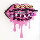 Light Pink Medium Lip Design Lipstick Organizer holding 23 lipsticks mounted on the wall, keeping lipstick organized and easy to reach. This wall mounted makeup organizer looks like art on the wall of your bathroom or makeup room.