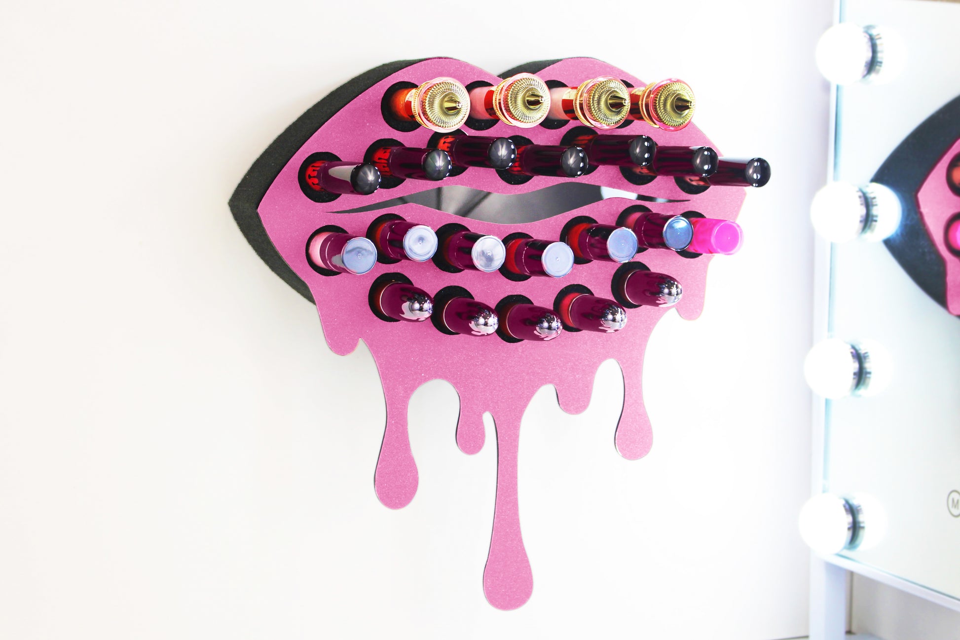Light Pink Medium Lip Design Lipstick Organizer holding 23 lipsticks mounted on the wall, keeping lipstick organized and easy to reach. This wall mounted makeup organizer looks like art on the wall of your bathroom or makeup room.