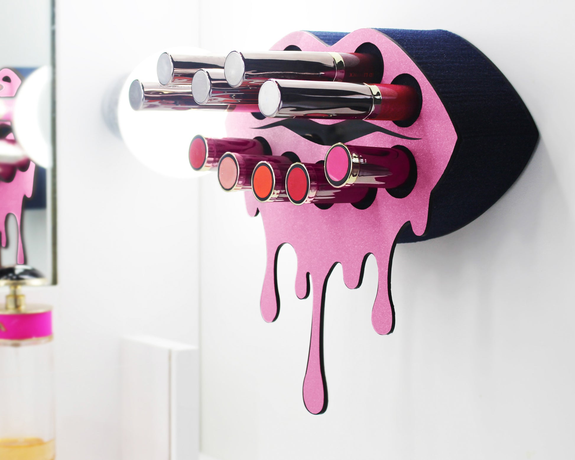 Black Small Lip Design Lipstick Organizer holding 10 lipsticks mounted on the wall with lipstick easily accessible and organized. Hanging Lipstick Holder that looks like wall art.