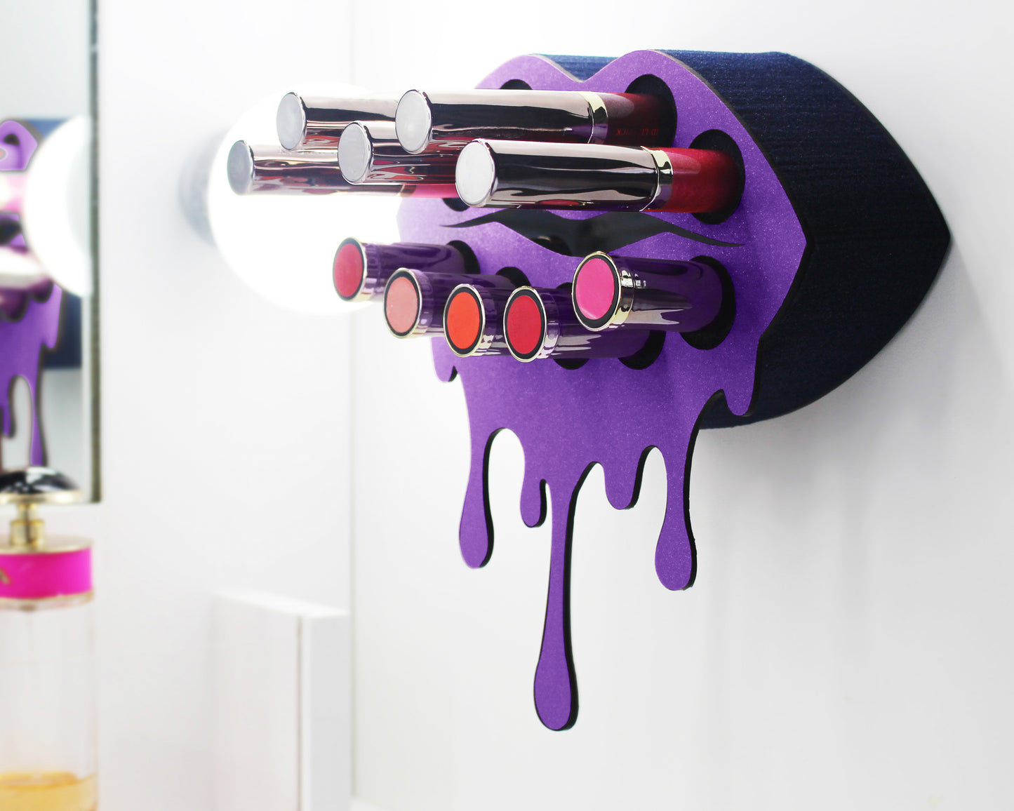 Black Small Lip Design Lipstick Organizer holding 10 lipsticks mounted on the wall with lipstick easily accessible and organized. Hanging Lipstick Holder that looks like wall art.