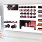 White Ultra Complete Makeup Solution Organizer shown mounted on the wall holding lipsticks, lip glosses, nail polishes, brushes, sunglasses and more by keeping items accessible and off of the counter. Shown next to a makeup vanity with samples of suggested items the organizer can hold. Tilted to the left to show depth.