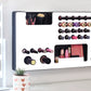 White Ultra Complete Makeup Solution Organizer shown mounted on the wall holding lipsticks, lip glosses, nail polishes, brushes, sunglasses and more by keeping items accessible and off of the counter. Shown next to a makeup vanity with samples of suggested items the organizer can hold. Tilted to the right to show the wall mounted makeup organizer at a different angle while still on the wall.